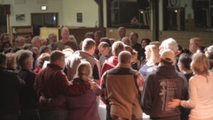people gathered around a communion table at the Northern California Prayer Summit