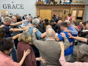 many people praying together in a circle