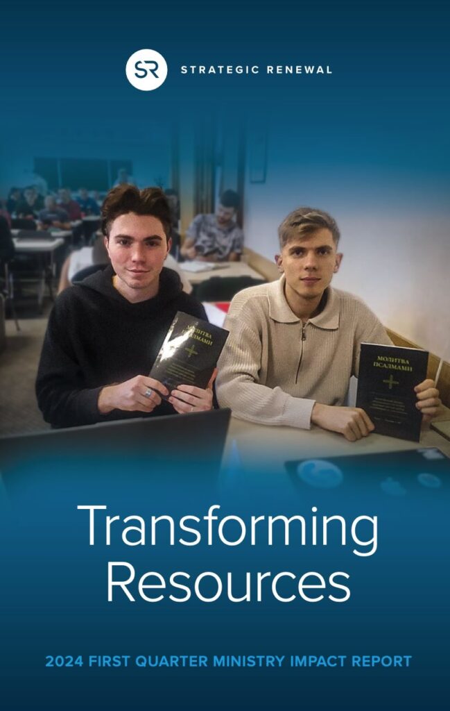 cover of the impact report that shows two young Russian men holding translated Praying the Psalms books in a Belarus Seminary