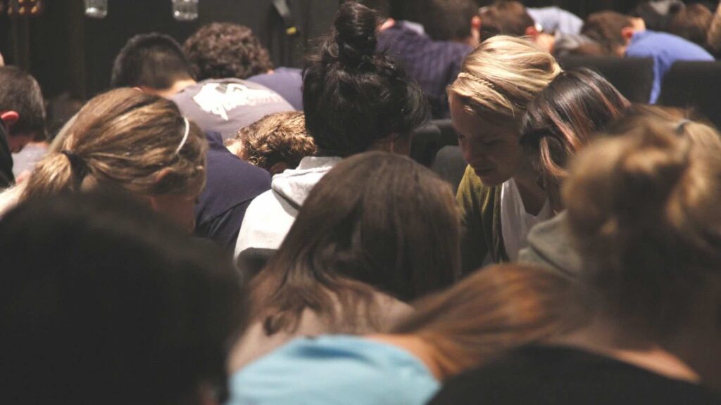 Women and men praying together