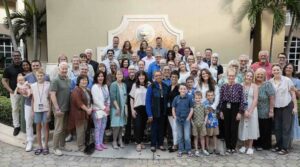 group of people posing for picture infant go a lion shaped fountain