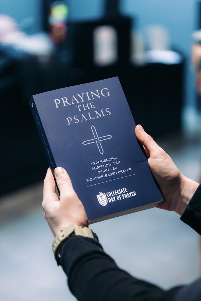 Praying the Psalms book held with two hands at Liberty University